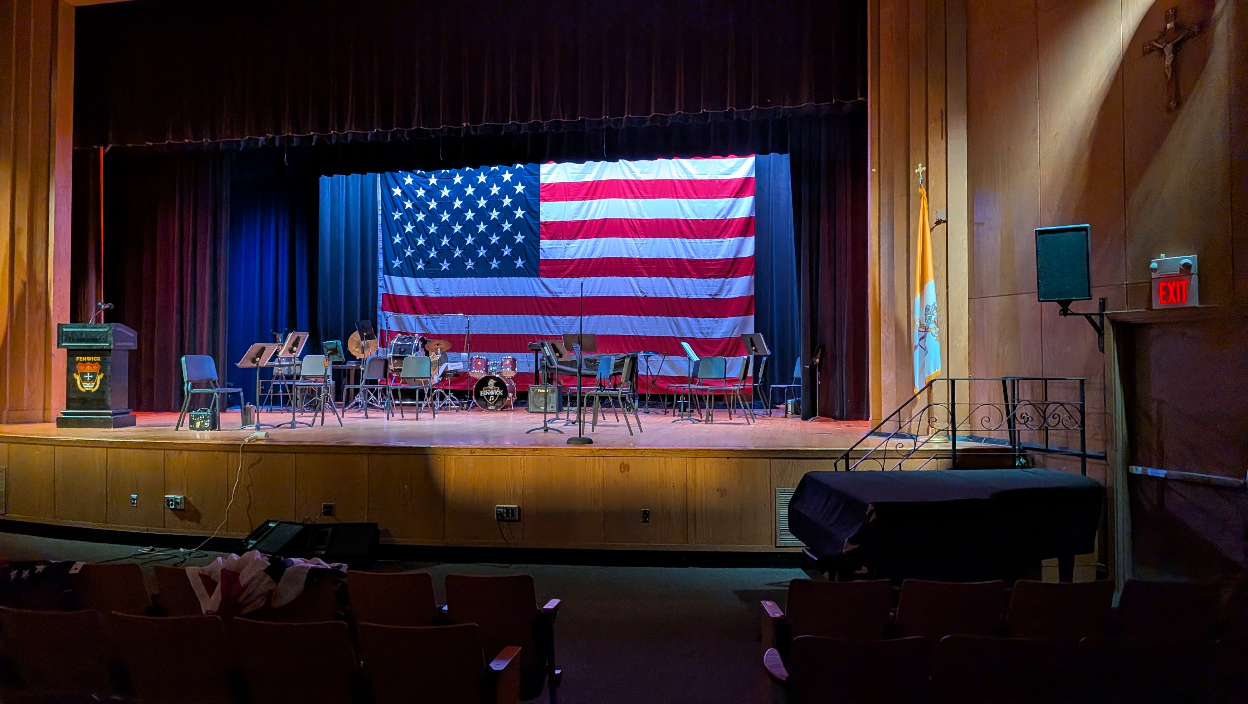A large American Flag hung upstage/in front of a cyclorama.